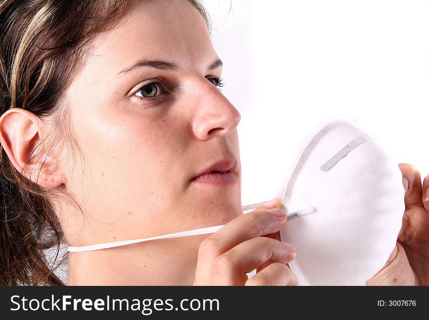 A young female doctor puts on her face mask!