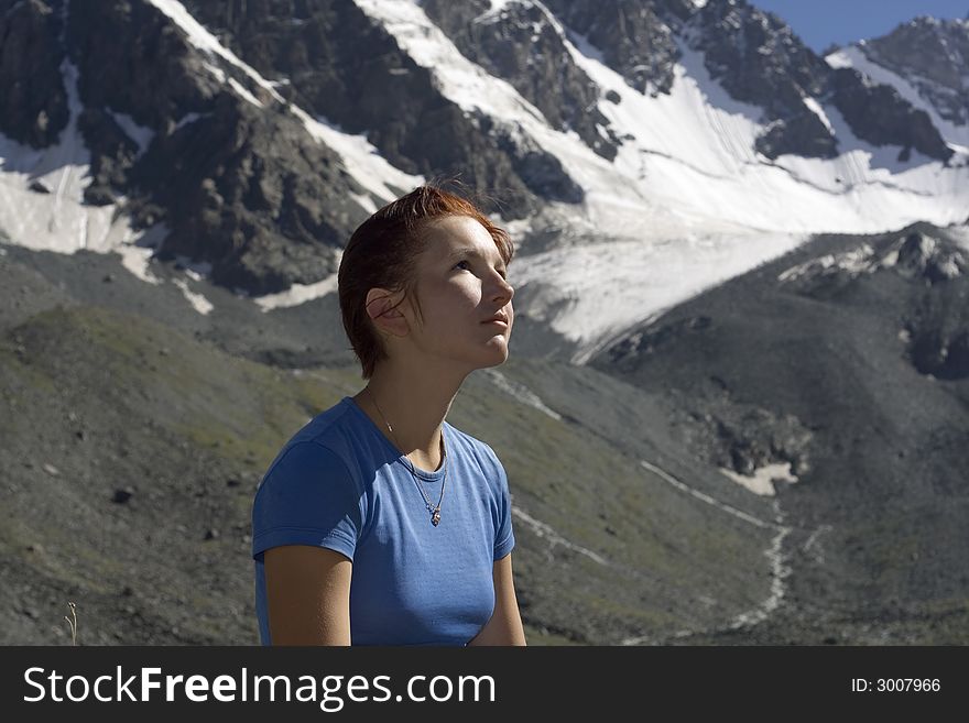 Dreaming girl with mountains as a background. Dreaming girl with mountains as a background
