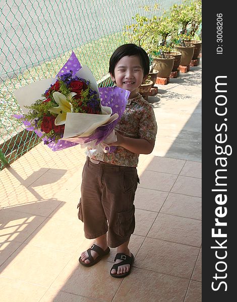 Boy holding rose bouquet