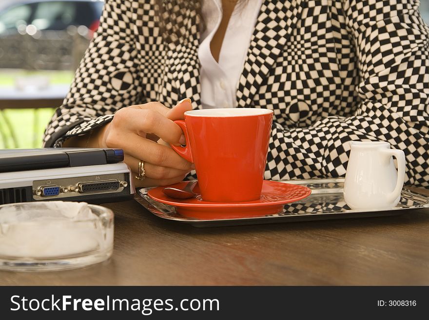 Image of a businesswoman enjoying a coffee break.