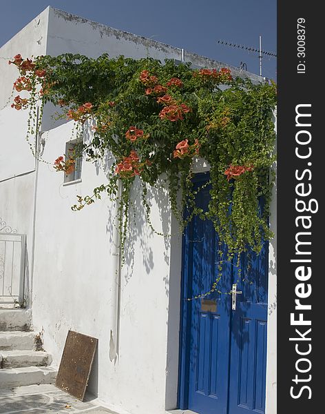 Greek island street scene with classic architecture and flowers on house