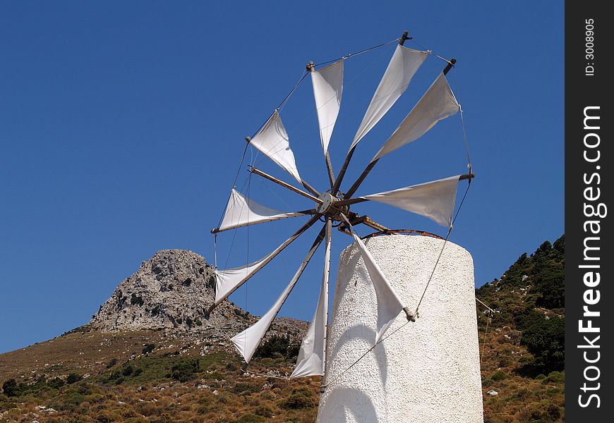 White greek typical windmill and blue sky