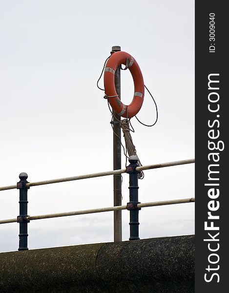 A lifebouy or lifesaving ring on a stand at the harbour. A lifebouy or lifesaving ring on a stand at the harbour