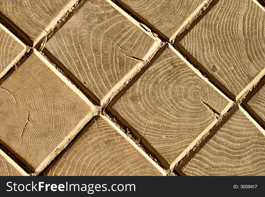 Square wooden bricks on a road