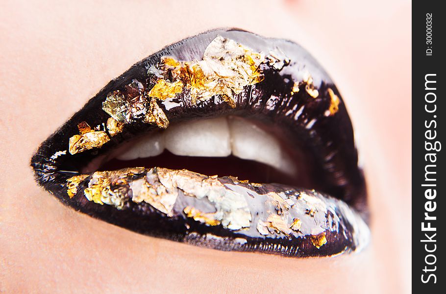 Creative glossy golden-black lips make up