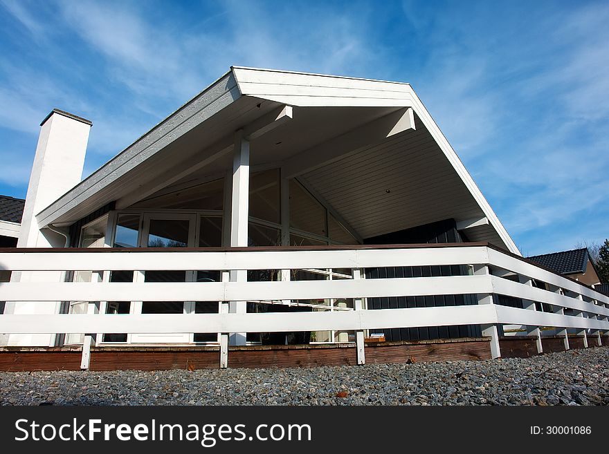 Modern style designed private wooden home summer house taken in low angle. Modern style designed private wooden home summer house taken in low angle