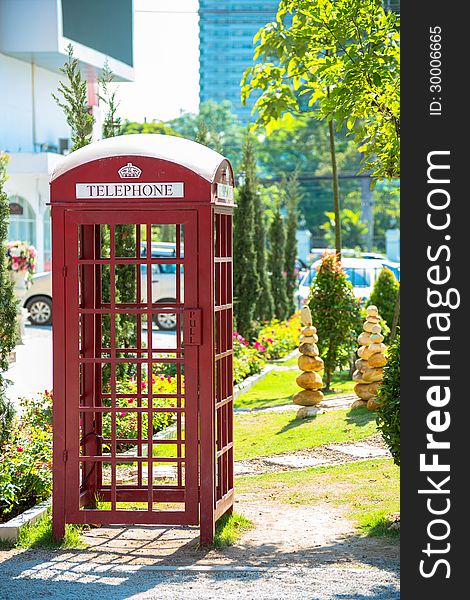 An outdoor red telephone box