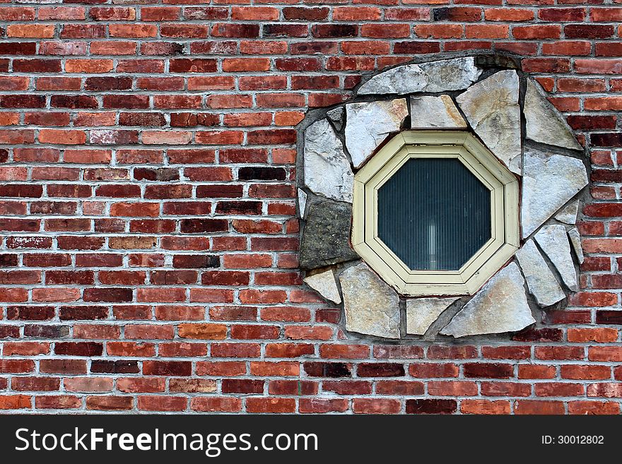 Octagon window surrounded by stone in a brick wall. Octagon window surrounded by stone in a brick wall.