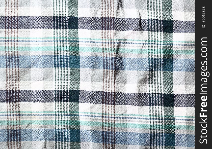 Wrinkled fabric plaid texture. Cloth background. Wrinkled fabric plaid texture. Cloth background