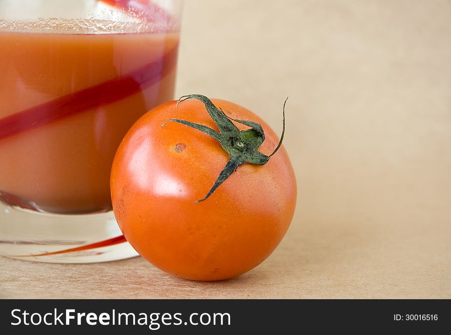 Close up fresh tomato with tomato juice on brown background. Close up fresh tomato with tomato juice on brown background