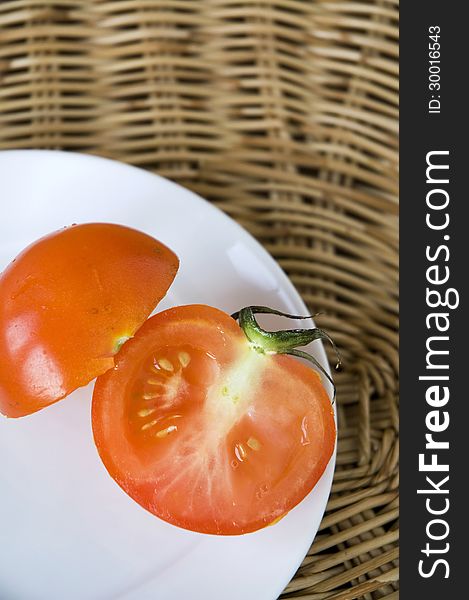 Piece of cutting fresh tomato on plate