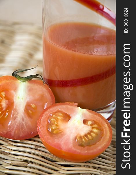 Cut half of fresh tomato with tomato juice. Cut half of fresh tomato with tomato juice