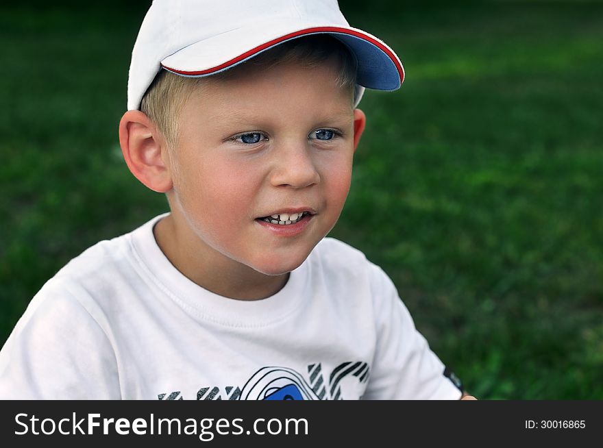 Boy in a baseball cap, emotional child, smiling boy