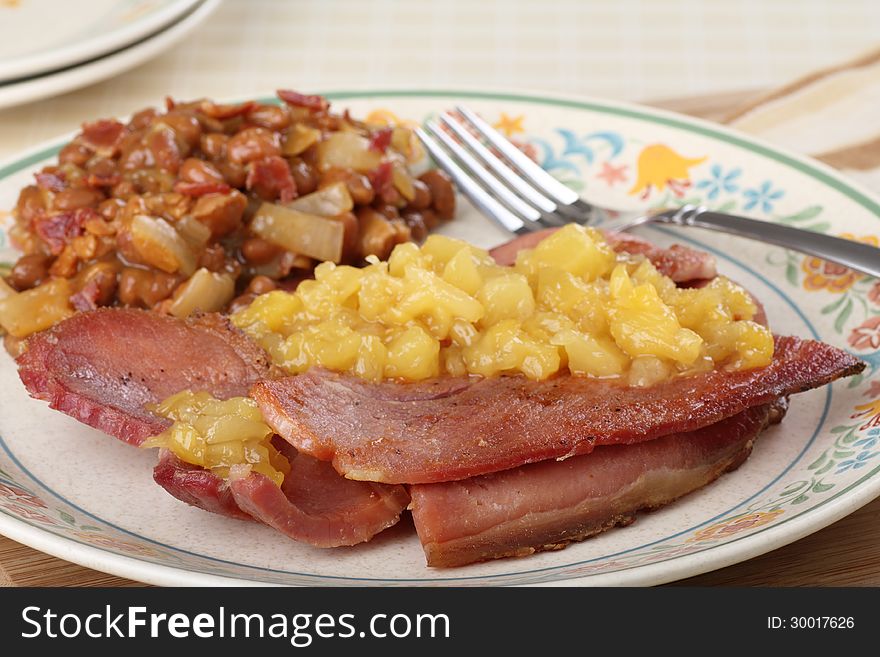 Fried ham with pineapple sauce on a plate. Fried ham with pineapple sauce on a plate