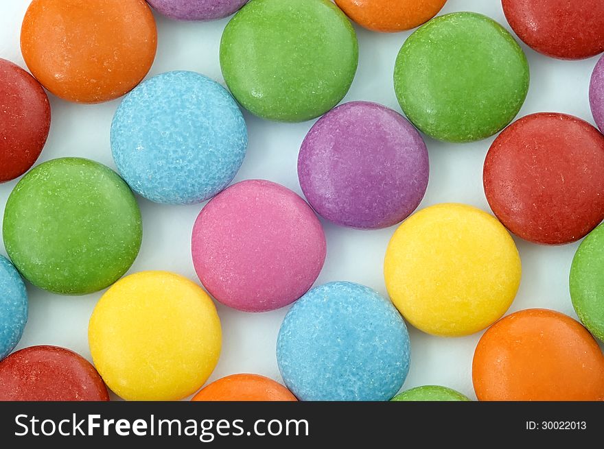 Colored chocolate candy on a white background. Colored chocolate candy on a white background