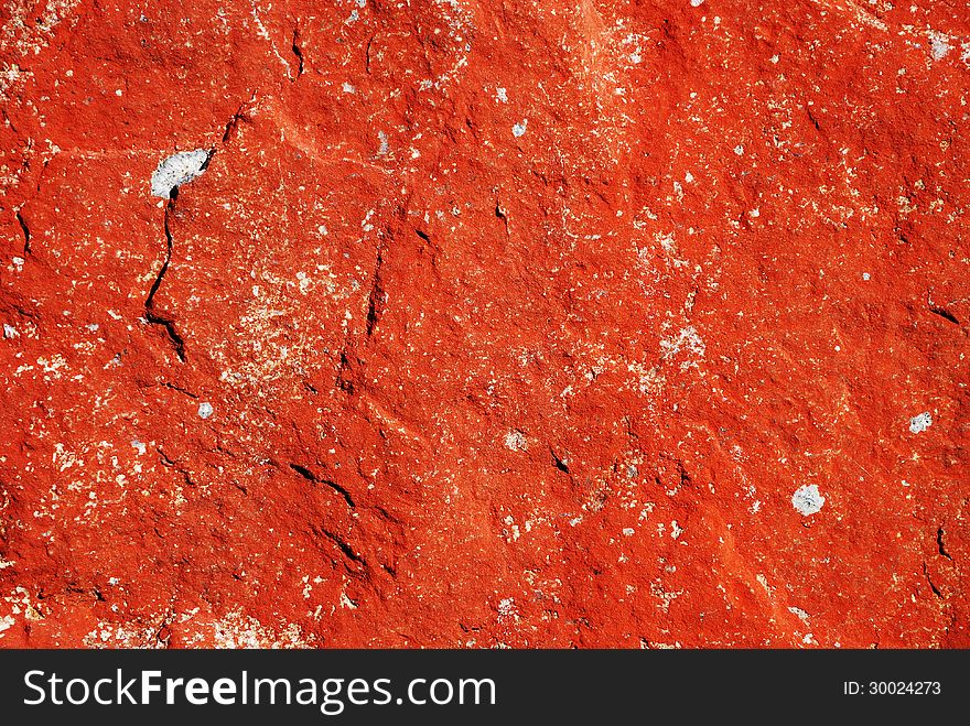 Red background of the mossy stone surface