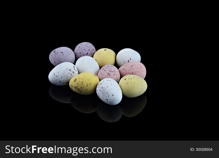 Group of small Easter eggs on black background