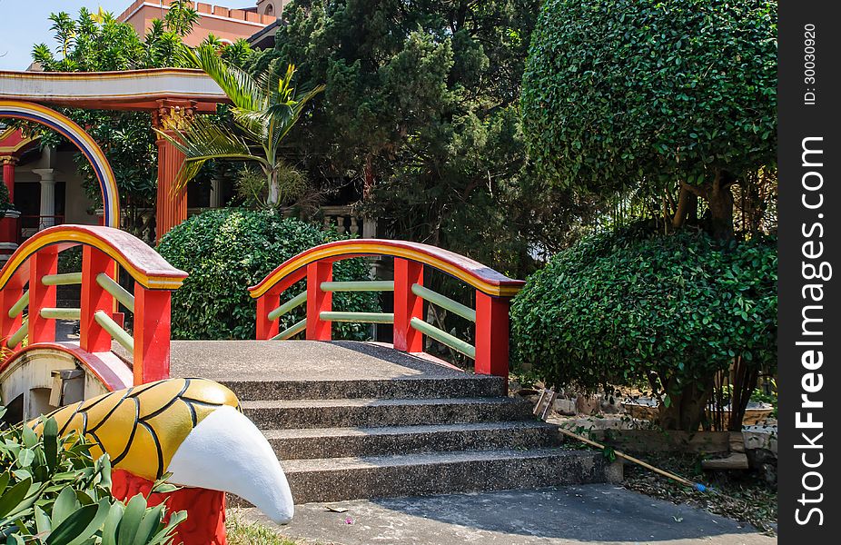 Chinese garden with red bridge