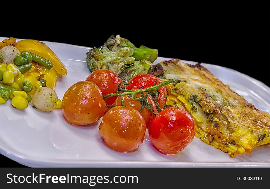 Vegetable Lasagne with fried Cherry tomatoes and vegetables.