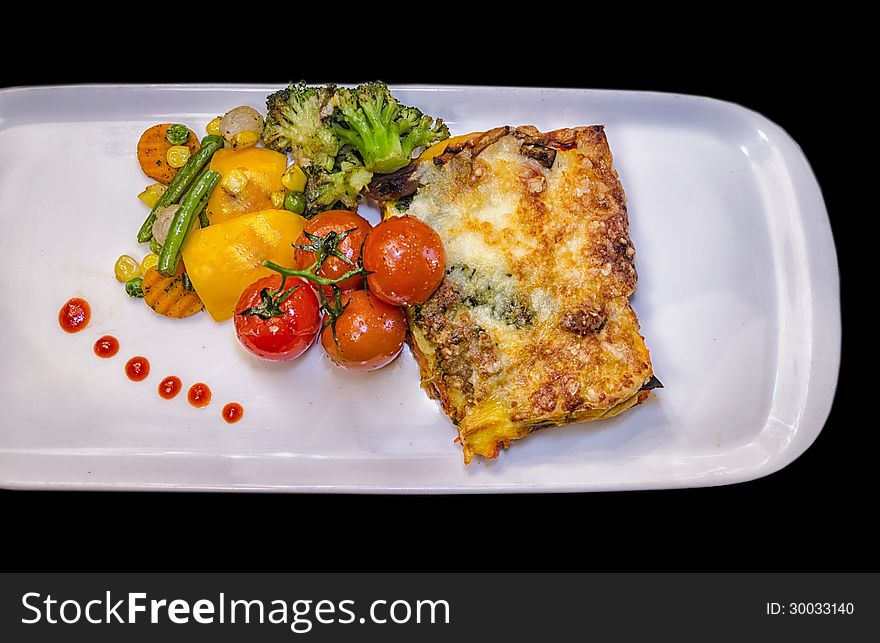 Vegetable Lasagne with fried Cherry tomatoes and vegetables.