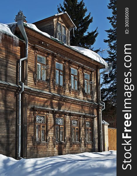 Old two-story wooden house, winter sunny day. Old two-story wooden house, winter sunny day