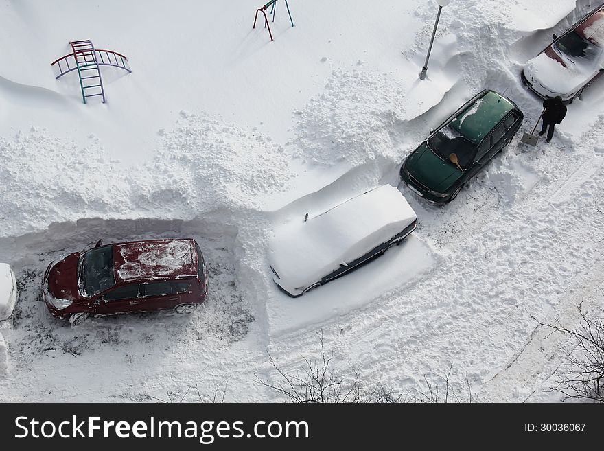 Man Clearing Snow from His Car