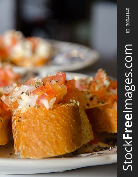 Italian bruschetta with slices fresh tomato and onion