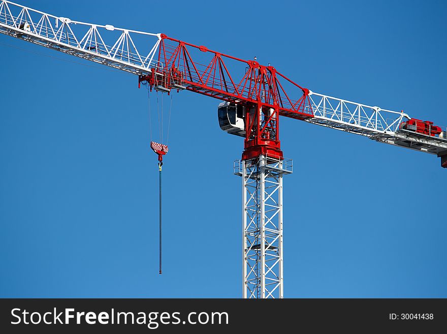 Tower crane closeup against blue sky