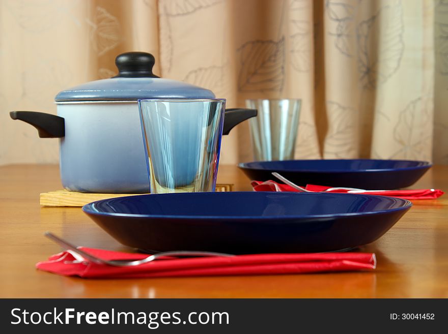 Table setting for two with ready dinner at home