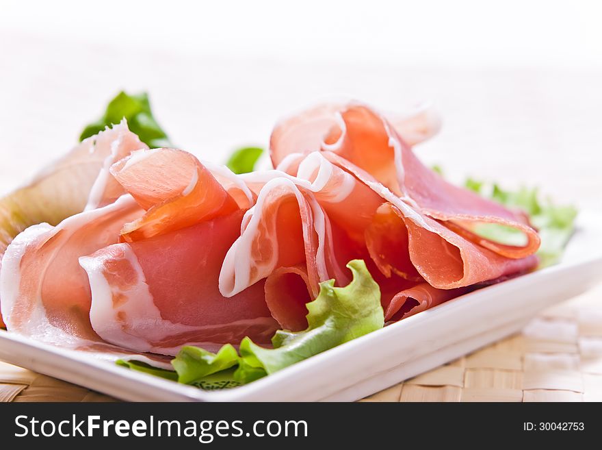 Ham and salad on a white plate