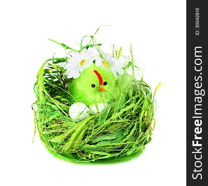 Easter eggs and bird in green grass nest with daisies isolated on white background