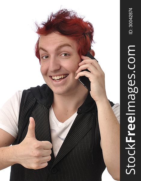 Young man gives a thumbs up as he talks on his smart phone communications device on white background. Young man gives a thumbs up as he talks on his smart phone communications device on white background