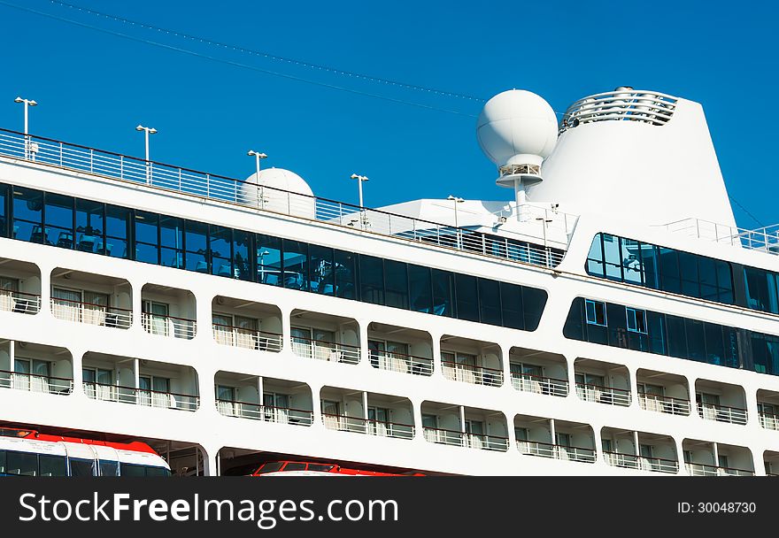 Sea travel background. Vacation on board the cruise liner - the portholes and top deck. View on luxury ocean liner. Seaside of the from the upper deck of a cruise ship.