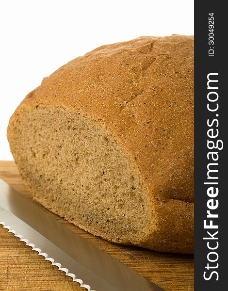 A bread with knife on cutting board on white background