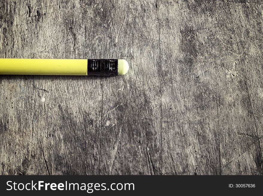 Classic graphite pencil lying on a table. School theme.