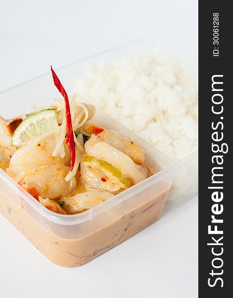 Prawn with lemon sauce from Thai cuisine in take away box with rice. Prawn with lemon sauce from Thai cuisine in take away box with rice.