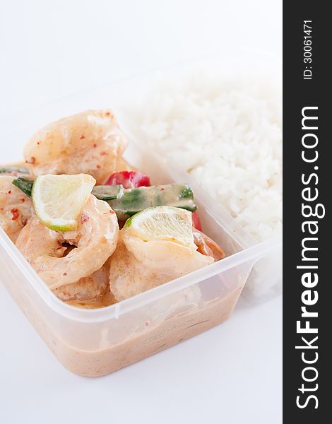 Prawn with lemon sauce from Thai cuisine in take away box with rice. Prawn with lemon sauce from Thai cuisine in take away box with rice.