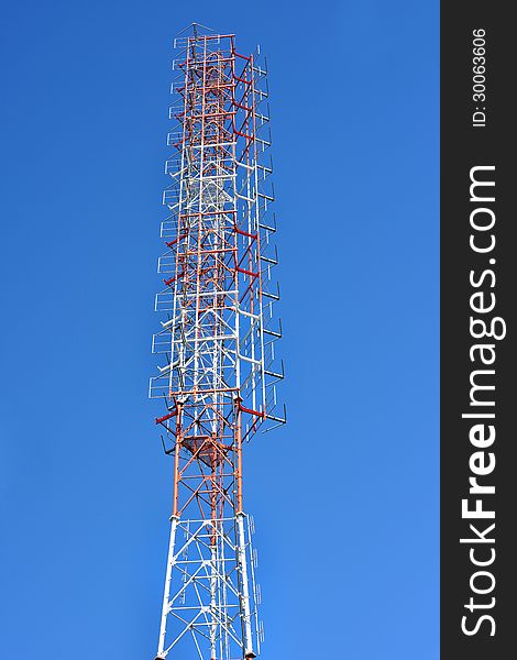 Telecommunication tower with a sunlight. Used to transmit television signals.