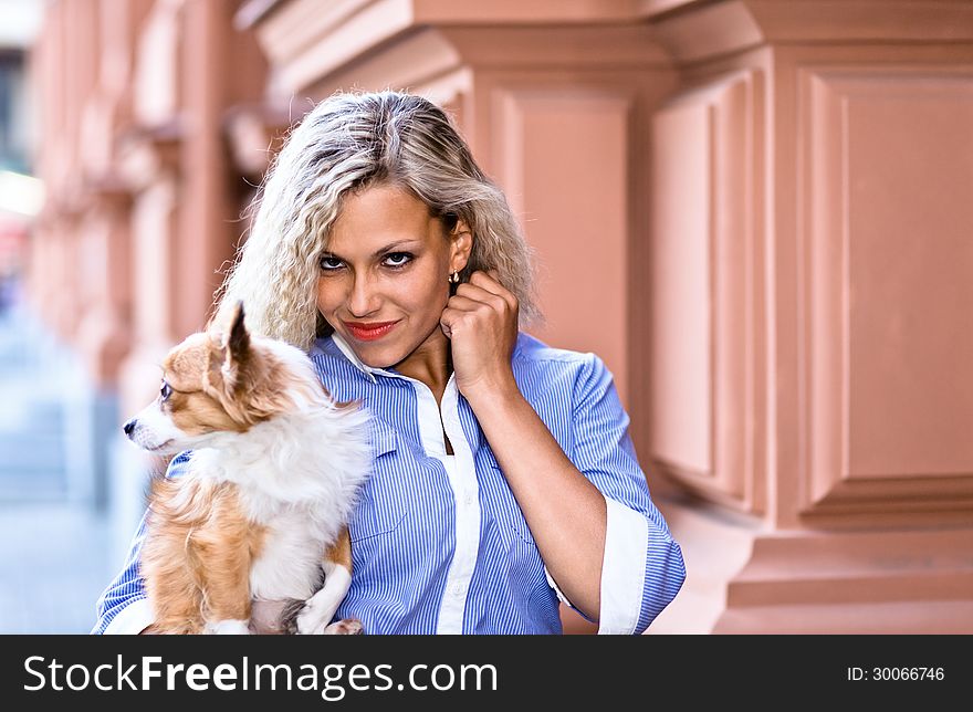 Young woman with chihuahua in old city.