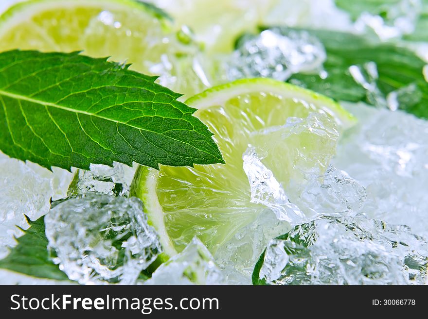 Slices of a lime and leaves of mint with ice. Slices of a lime and leaves of mint with ice