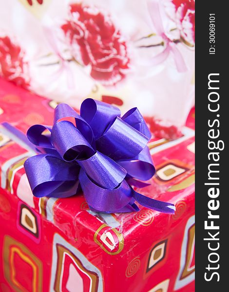 Gift paper box with blue ribbon bow