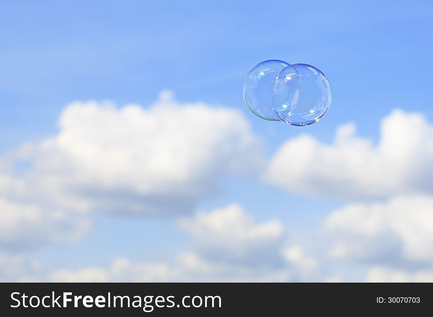 Bubbles against the blue sky with clouds.