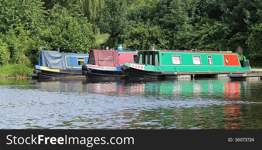 Three Narrow Boats at a Canal Mooring Point. Three Narrow Boats at a Canal Mooring Point.