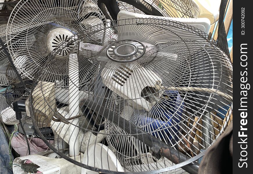 A pile of old fan frames at the electronics repair shop