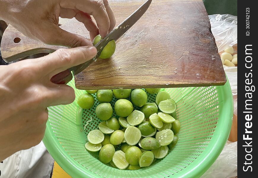 A Man& X27 S Hand Cuts A Lime Using A Sharp Knife