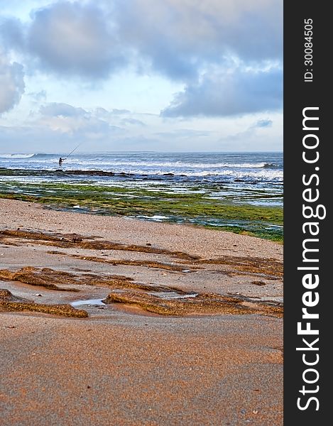 Fisherman  With Fishing Rod On The Beach