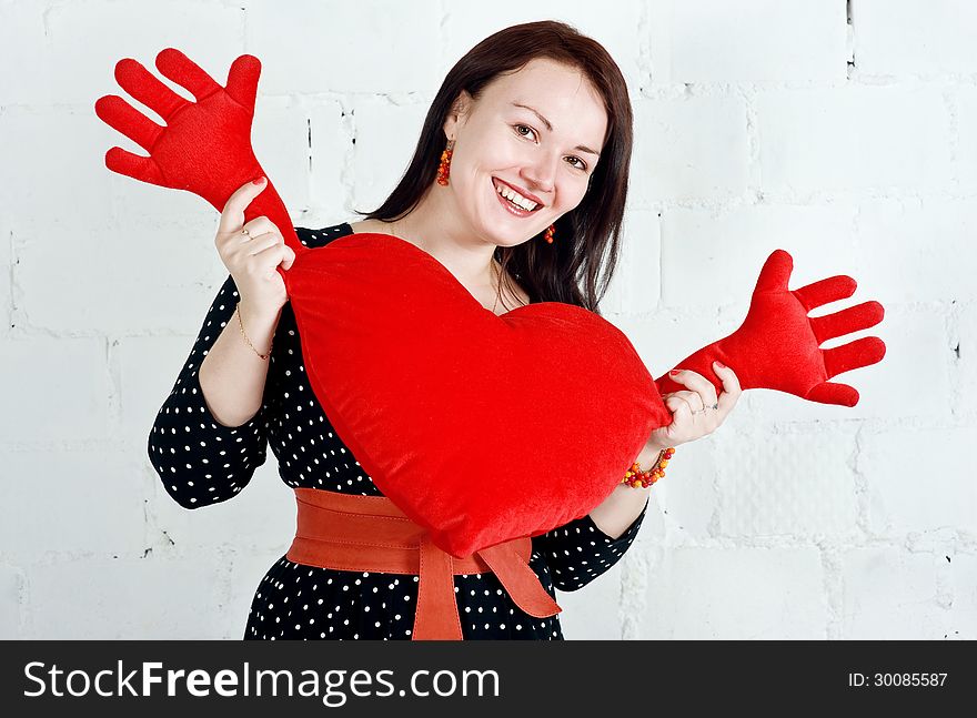 Woman with red heart toy