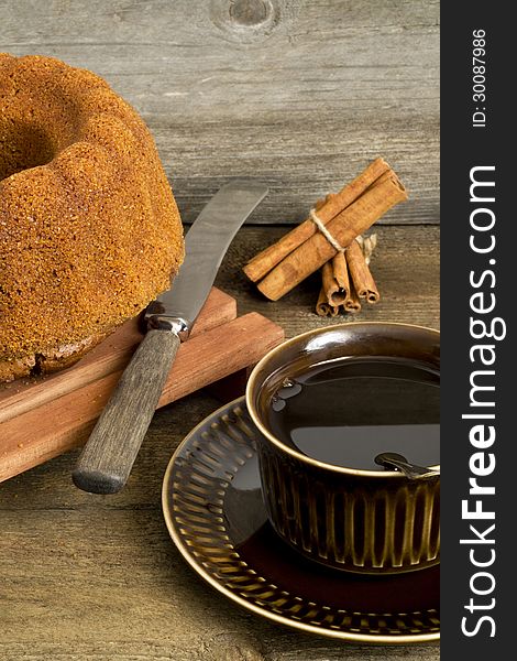 Homemade coffee cake, cinnamon sticks and cup of coffee. Homemade coffee cake, cinnamon sticks and cup of coffee