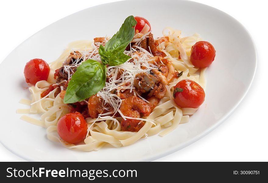 Seafood pasta with tomato sauce, decorated with cherry tomatoes. Seafood pasta with tomato sauce, decorated with cherry tomatoes