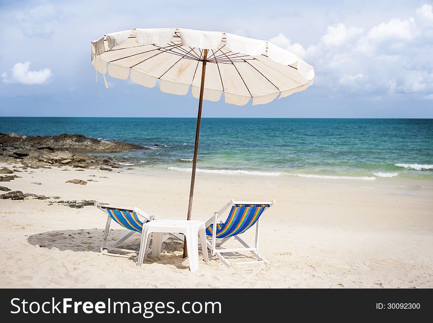 Beautiful beach with chairs and umbrella